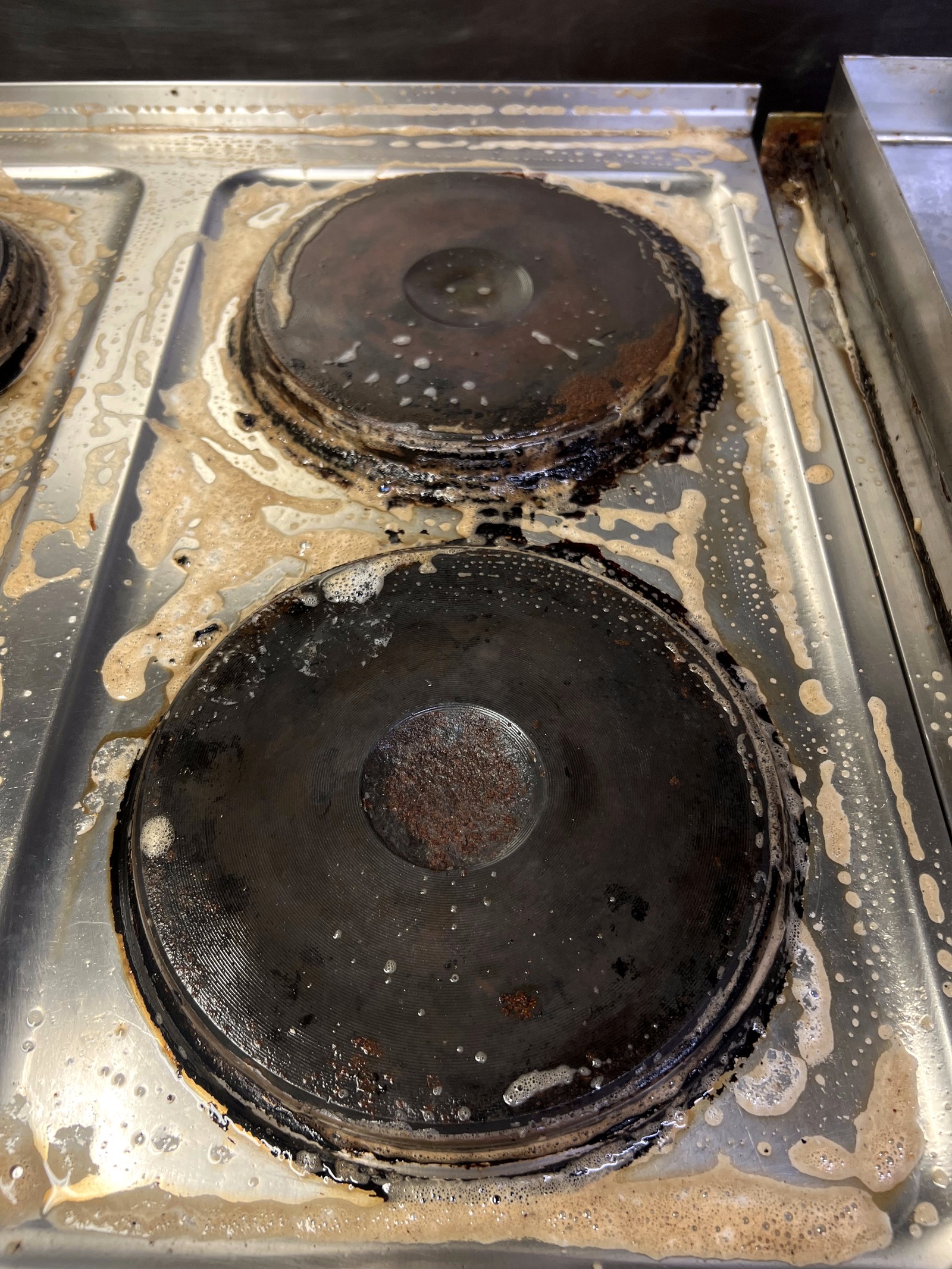 Electric hob before clean — heavily soiled